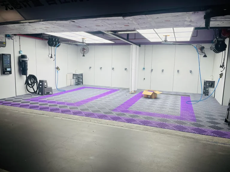 Garage floor with grey tiles and purple bay markings