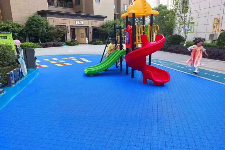 Blue interlocking floor tiles in a community play area