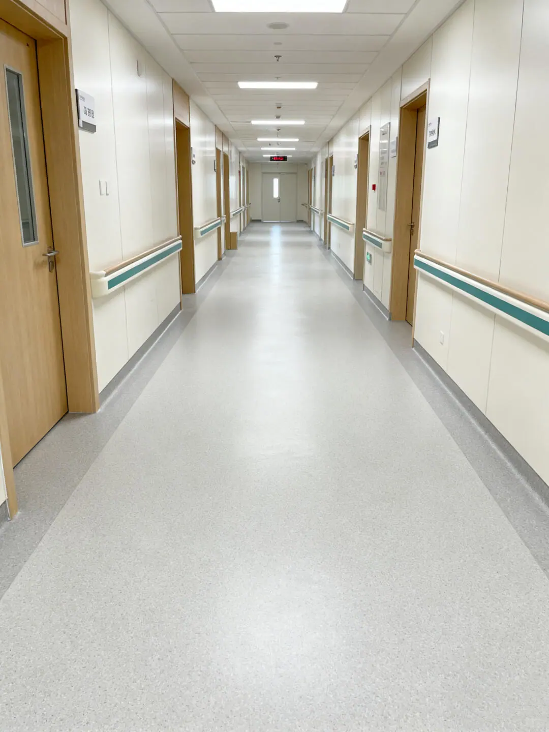 Healthcare corridor with a light floor and doorways