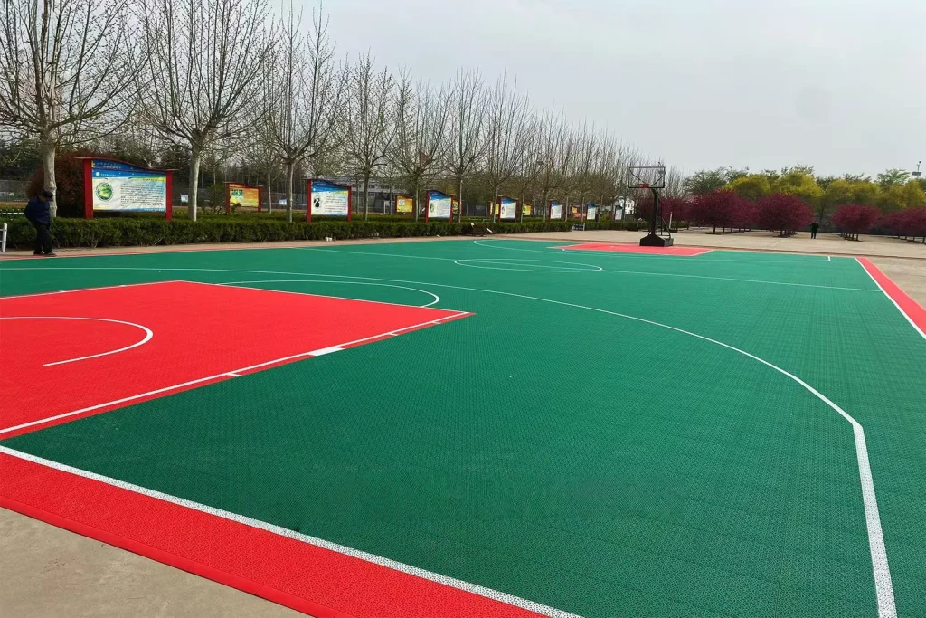 Red and green community court beside landscaped surroundings