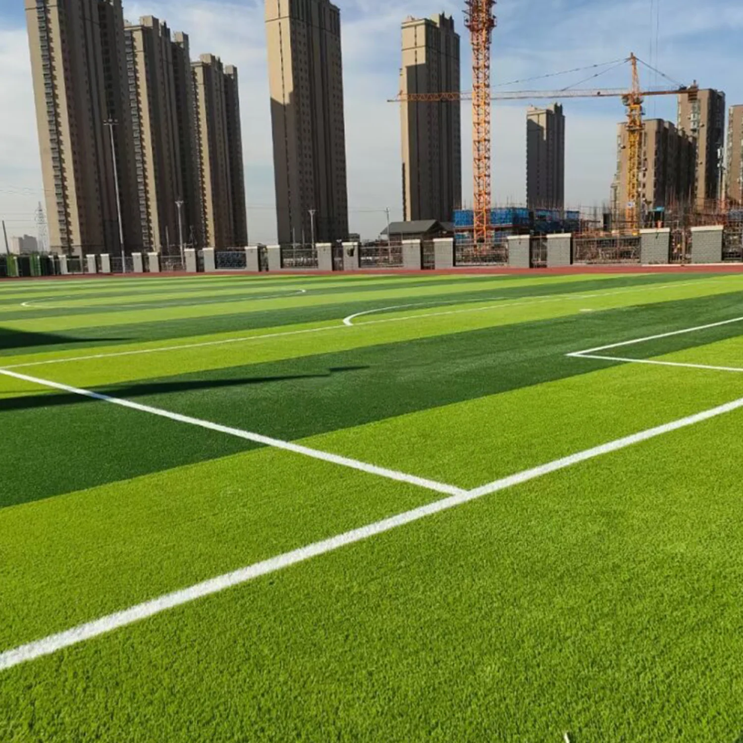 Artificial grass football field with white touchline markings