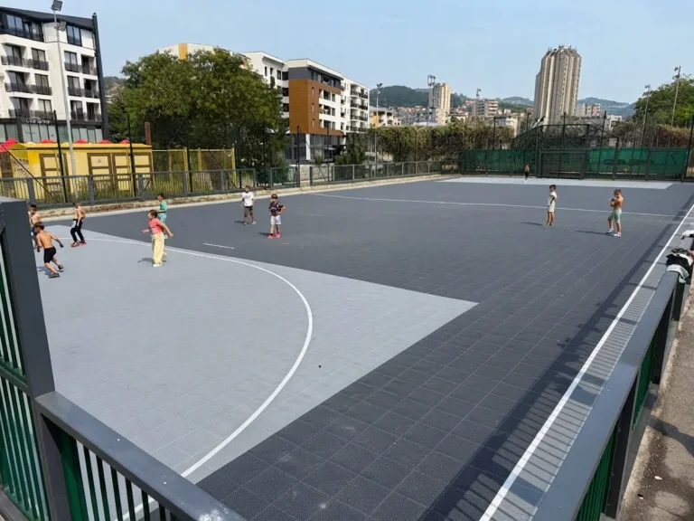 Grey outdoor small-sided court with white football markings
