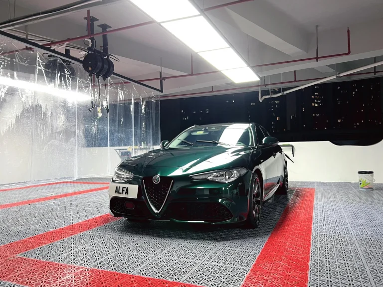 Car parked on a grey and red interlocking garage floor