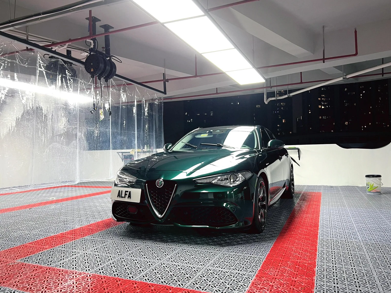 Car parked on a grey and red interlocking garage floor