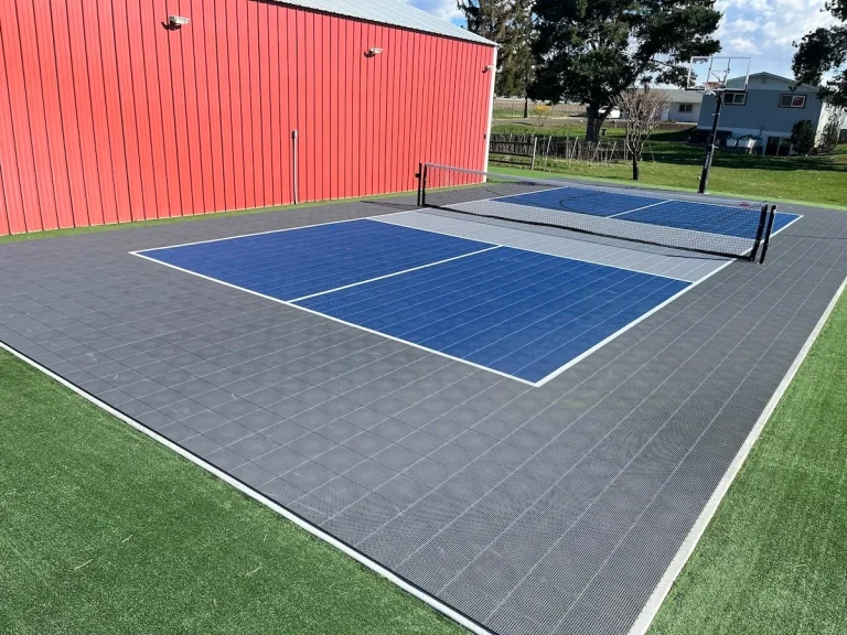 Outdoor blue pickleball court with a net
