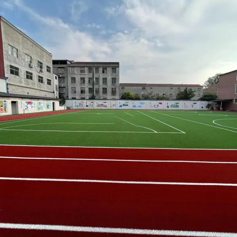 School playing field alongside a red running track